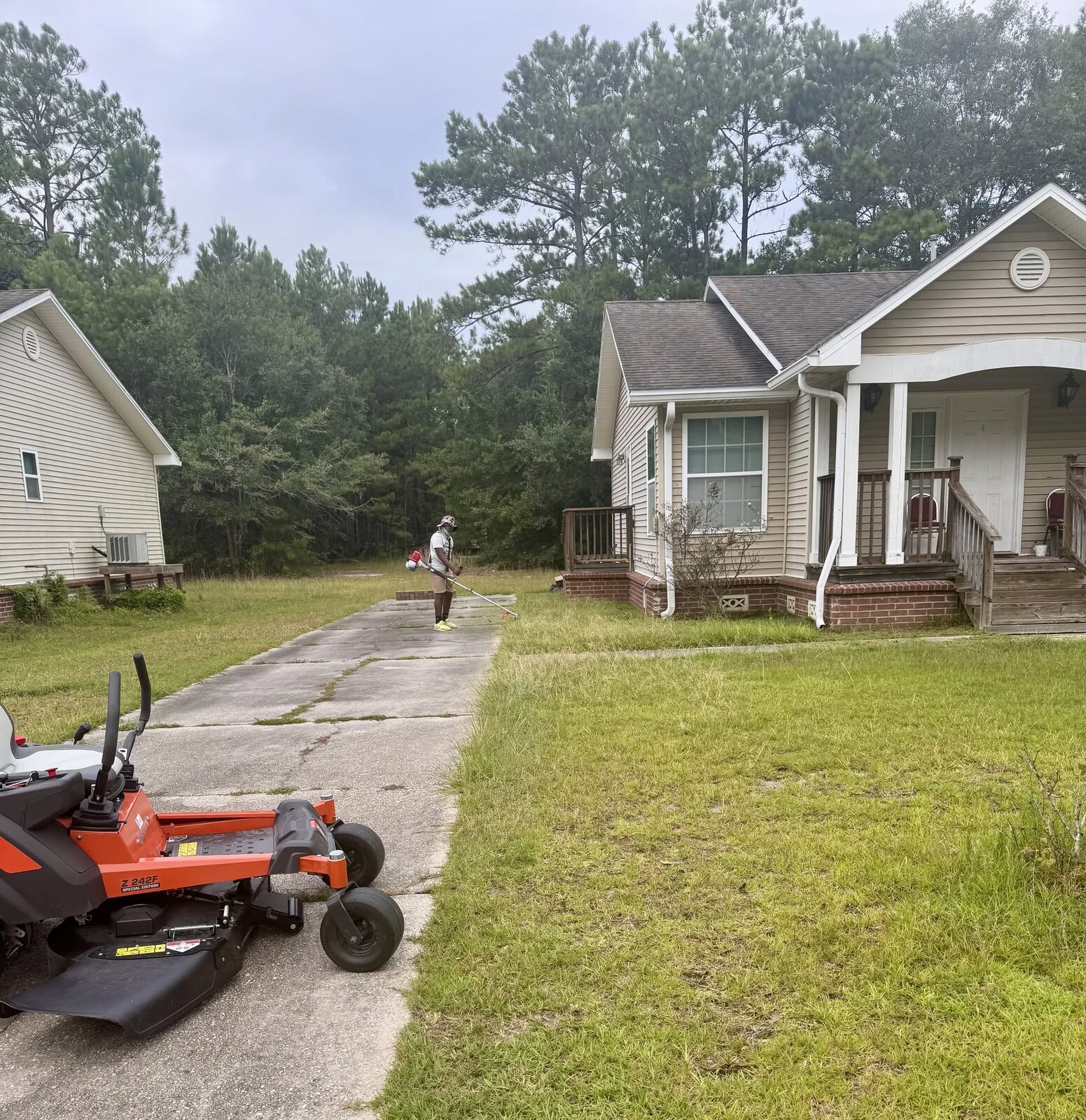 Zero-turn mower and trimming work at a Slidell home